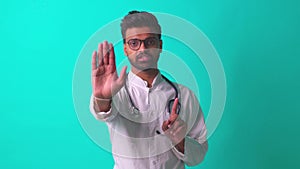 young latin hispanic medican man wear eye glasses with stethoscope telling bad news in blue studio wall background