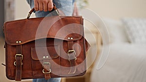 Young latin man business worker holding briefcase at hotel room