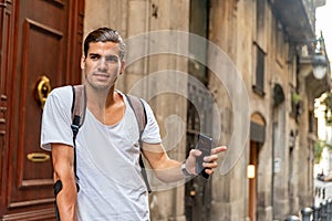 Young latin man with crutches stopping a taxi in the street