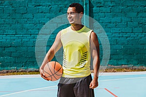 Young latin man playing basketball portrait in Mexico photo