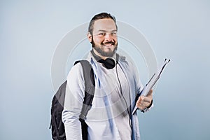 Young latin man student university on blue background in Mexico Latin America