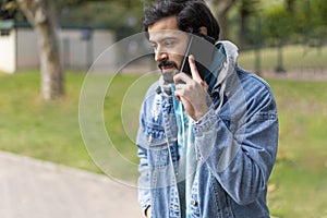 Young latin man talking on cell phone