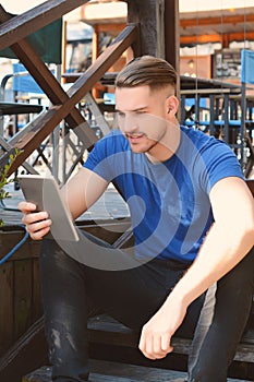 Young latin man using a tablet
