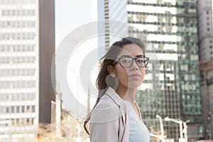 Young latin professional woman with glasses in the city