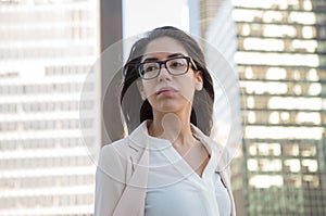 Young latin professional woman with glasses in the city