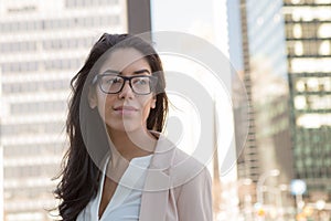 Young latin professional woman with glasses in the city