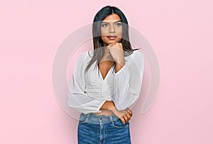 Young latin transsexual transgender woman wearing casual clothes with hand on chin thinking about question, pensive expression
