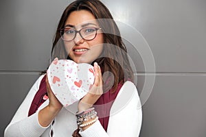 Young latin woman with box of heart chocolates. Valentine`s Day