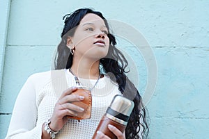 Young latin woman drinking traditional yerba mate tea.