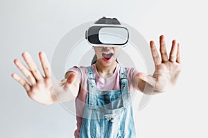 Young latin woman with glasses of virtual reality on a white background. Future technology concept. Modern imaging technology in L