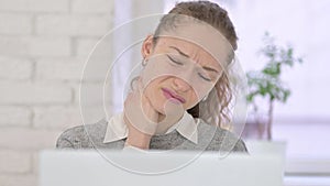 Young Latin Woman having Neck Pain in Office