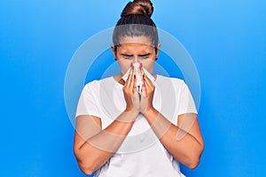 Young latin woman illness using paper handkerchief on nose