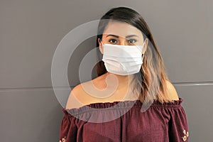 Young latin woman with multilayer face masks for clinical use to prevent covid photo