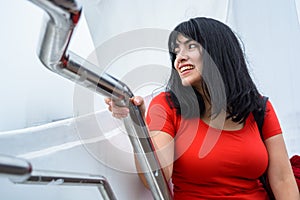 young latin woman sitting on Puente De La Mujer in Buenos Aires, smiling enjoying the vacation day photo