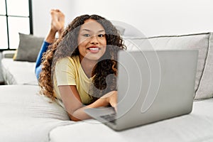 Young latin woman smiling confident using laptop at home