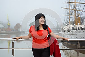 young latin woman tourist standing on the Puente De La Mujer in Buenos Aires looking to the side photo