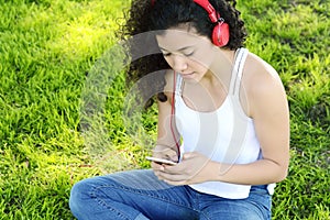 Young latin women sending message with smartphone.