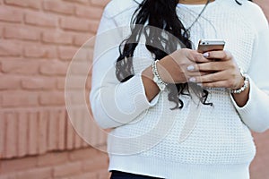 Young latin women sending message with smartphone.