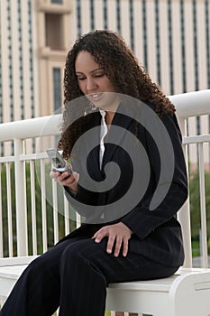 Young Latina Business Woman Messaging