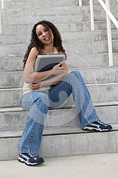 Young Latina Student Hugging Computer