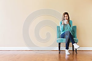 Young latina woman drinking coffee