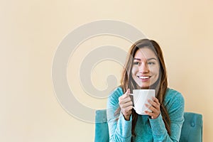 Young latina woman drinking coffee