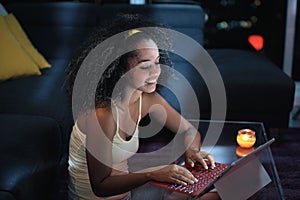 Young Latina Woman Typing Message on Laptop At Night