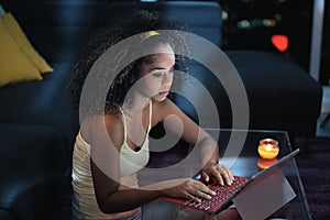 Young Latina Woman Typing Message on Laptop At Night