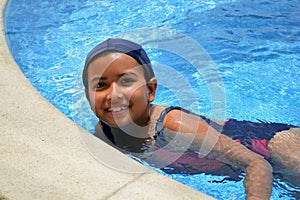 Young latinamerican girl in the swimming pool. photo