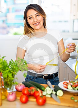 Young latino girl eating green salad to lose weight