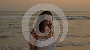 Young latino girl happily having fun and laughing at the ocean.