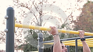 Young latino man in black pants doing exercises in a calisthenics