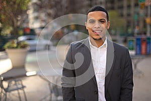 Young Latino man in city smile face photo