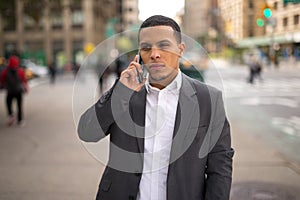 Young Latino man in city talking on cell phone