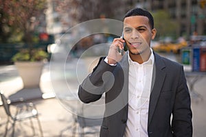 Young Latino man in city talking on cell phone