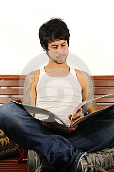 Young latino man reading