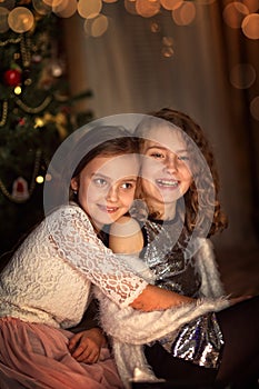 Young laughing girls on Christmas Eve