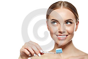 Young laughing woman with great stunning snow-white teeth. Girl with a healthy smile with a brush, toothpaste and floss