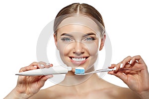 Young laughing woman with great stunning snow-white teeth. Girl with a healthy smile with a brush, toothpaste and floss