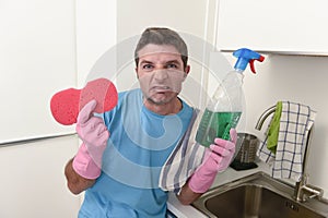 Young lazy house cleaner man washing and cleaning the kitchen tired in stress