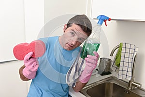 Young lazy house cleaner man washing and cleaning the kitchen tired in stress