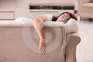 Young lazy man in oversleeping concept at home