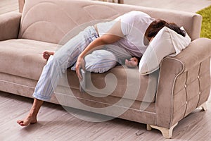 Young lazy man in oversleeping concept at home