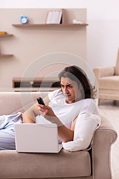 Young lazy man in oversleeping concept at home