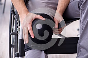 Young leg injured man in wheel-chair