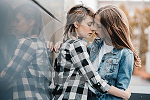 Young lesbian couple hugging and kissing outdoors