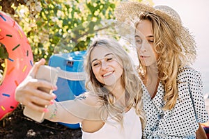 Young lesbian`s couple having fun and spending time at riverside in sunny day