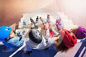 Young in-line skaters sitting on stairs outdoors