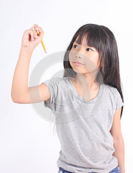 Young little asian girl writing something with yellow pencil