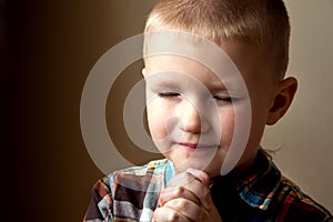 Young little boy praying